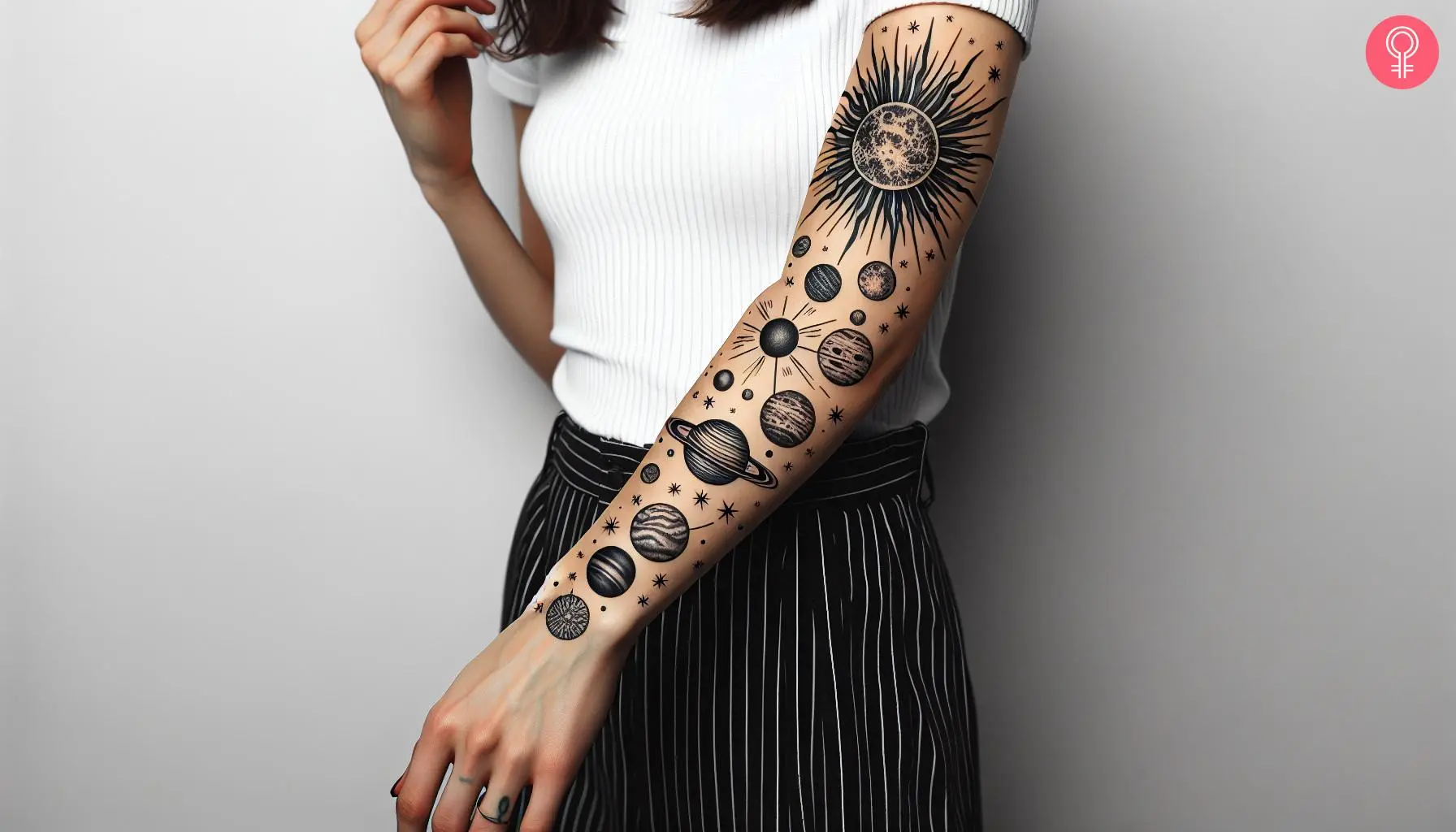 A woman with a black solar system tattoo design on her forearm