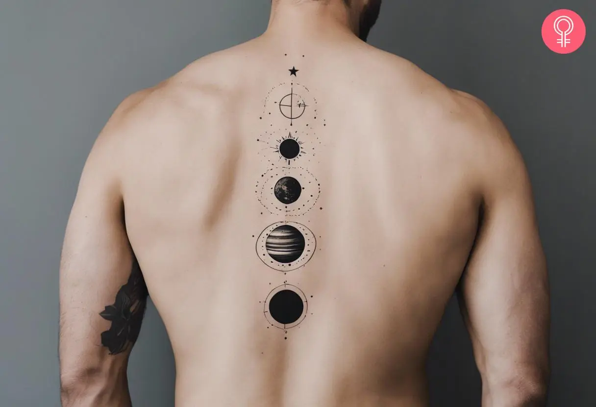 A man with a minimalist solar system tattoo on his spine