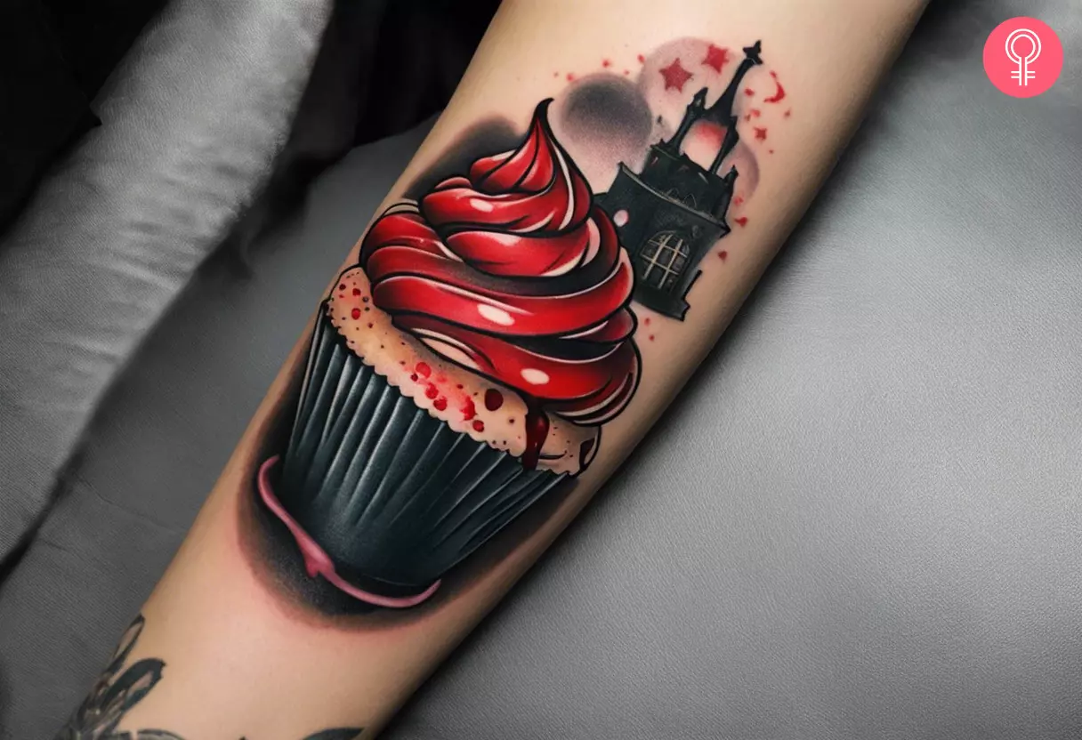 Woman showing her spooky cupcake tattoo on the forearm