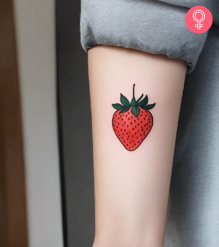 Aesthetic strawberry tattoo on the upper arm
