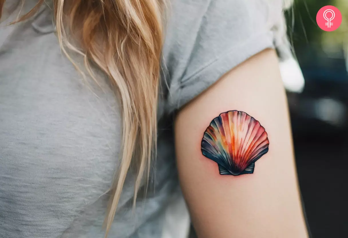 Tattoo of a colorful seashell on a woman’s arm