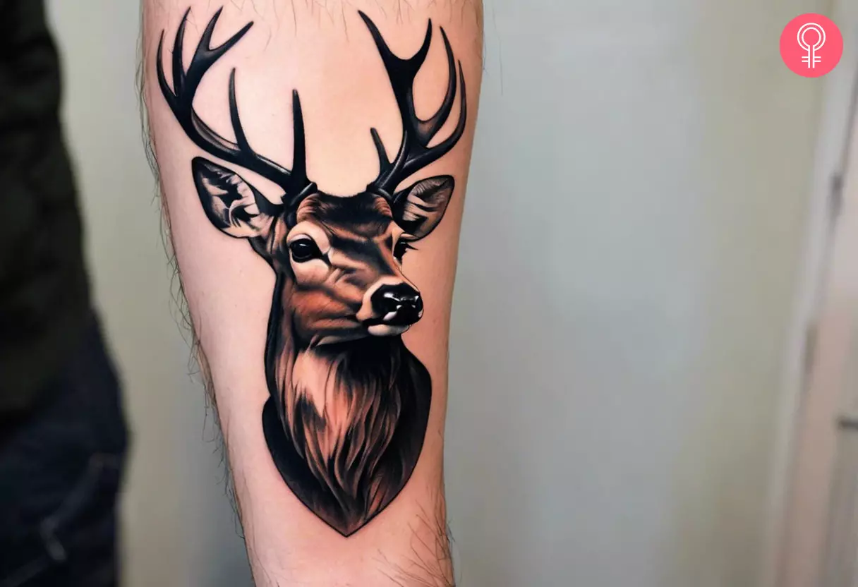 Tattoo of a deer head on a man’s arm