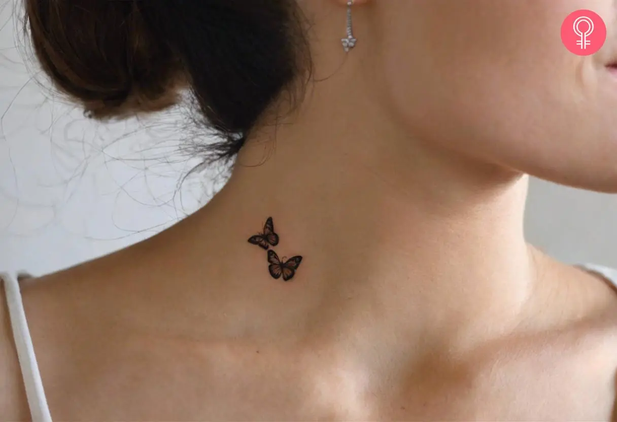 A thin butterfly tattoo on a woman’s neck