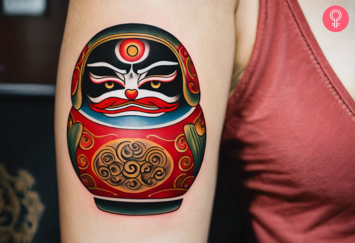Traditional Daruma doll tattoo on a woman’s arm