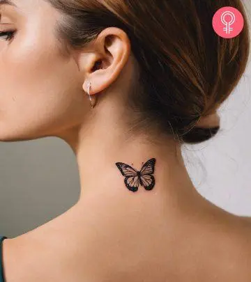 A butterfly tattoo on a woman’s neck