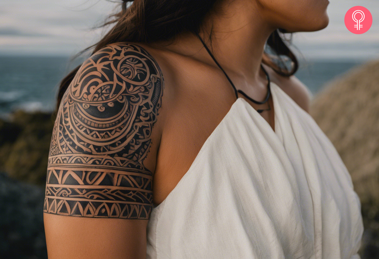 Upside down semicircle maori shoulder tattoo on a woman