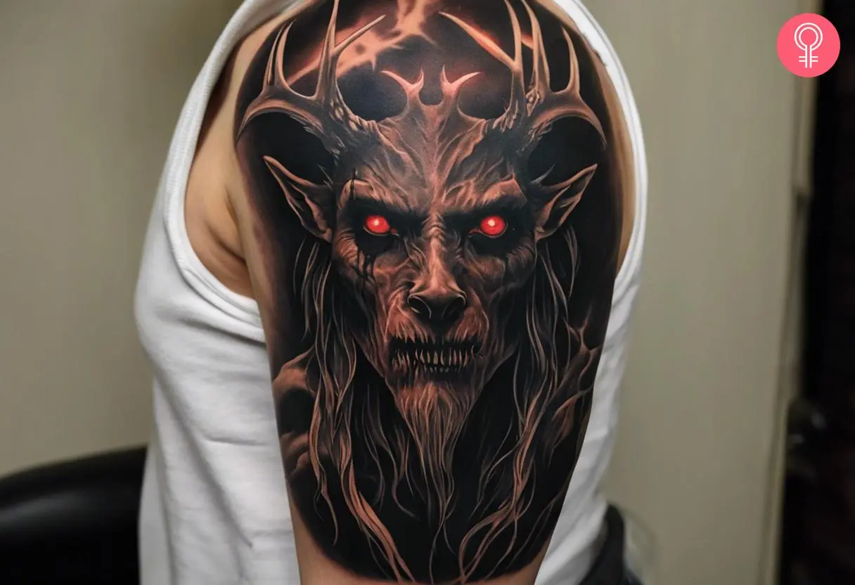 A wendigo head tattoo on the upper arm