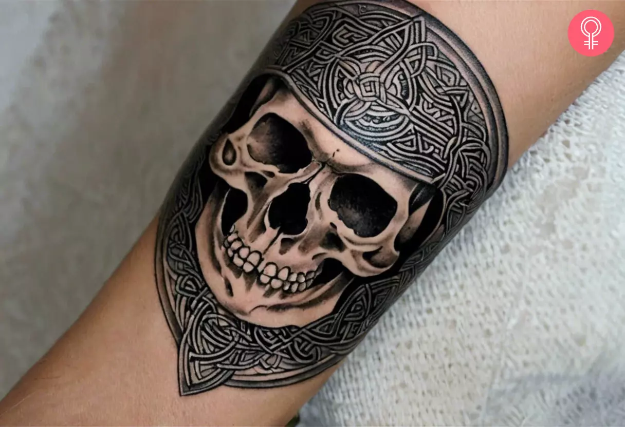 Woman with Celtic skull tattoo on her forearm