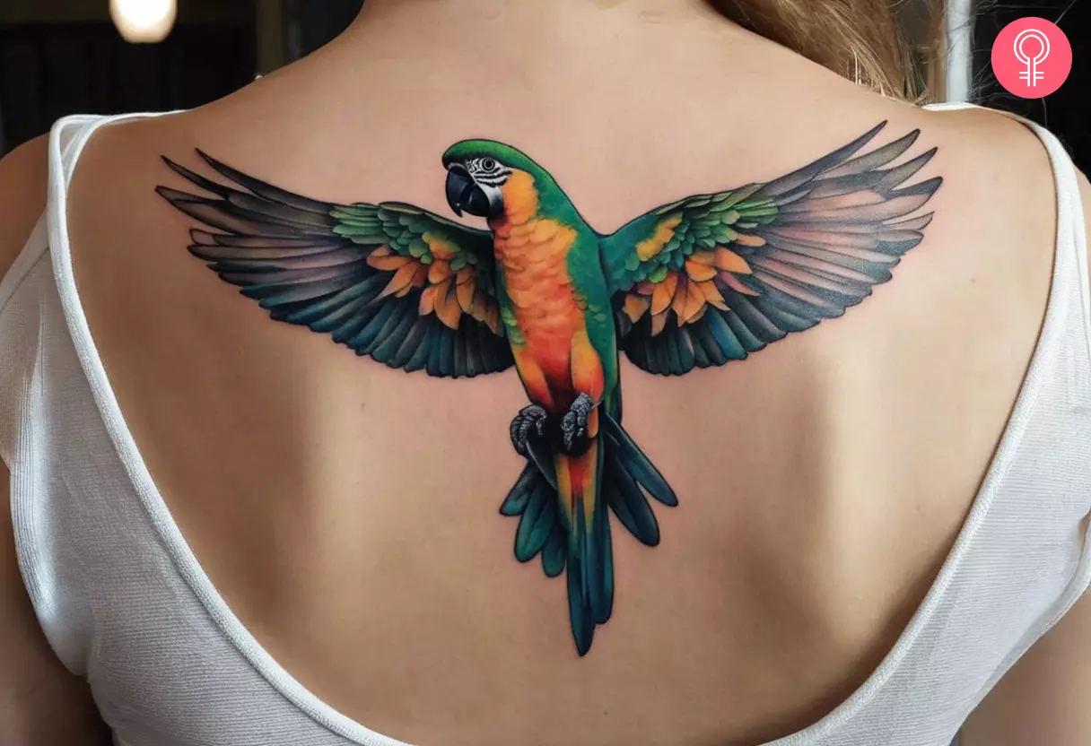 Woman with a flying parrot tattoo on her upper back