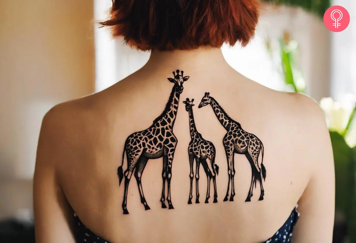 Woman with a giraffe family tattoo at the back