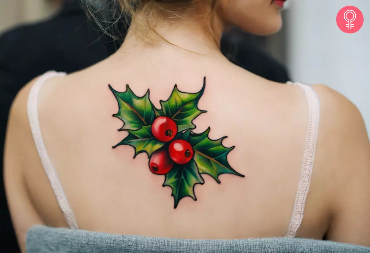 Woman with a holly tattoo on her back