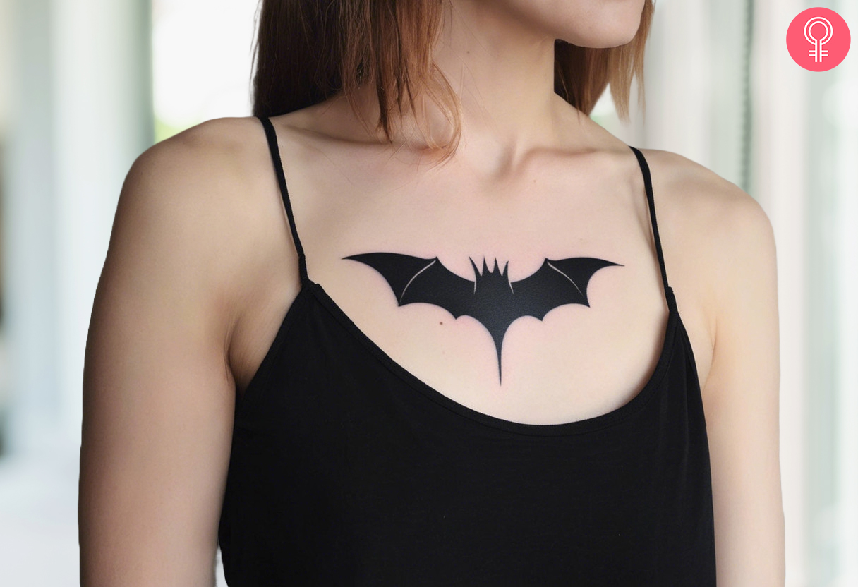 Woman with a minimalist gothic tattoo of a bat