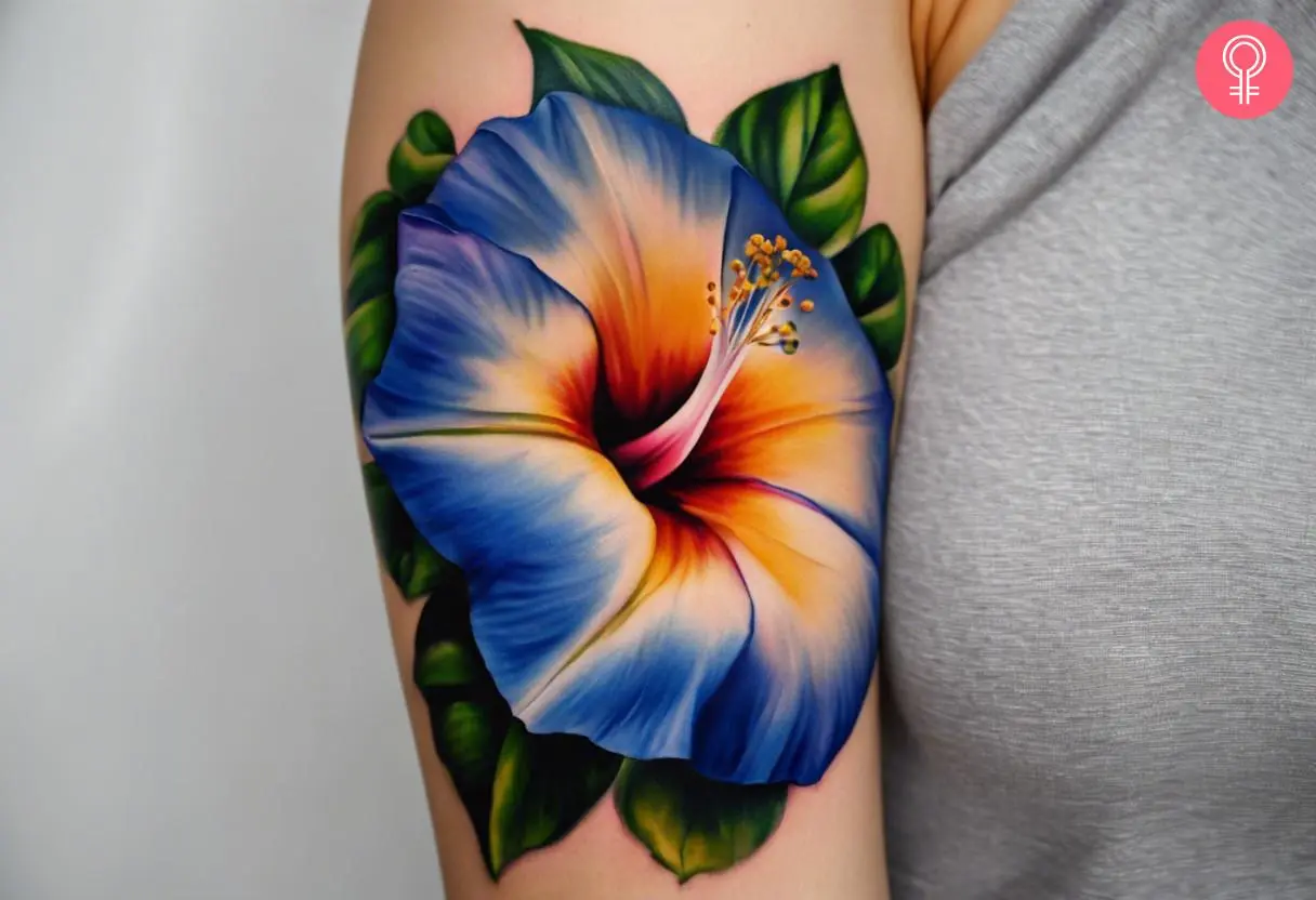 Woman with a realistic morning glory tattoo on her upper arm