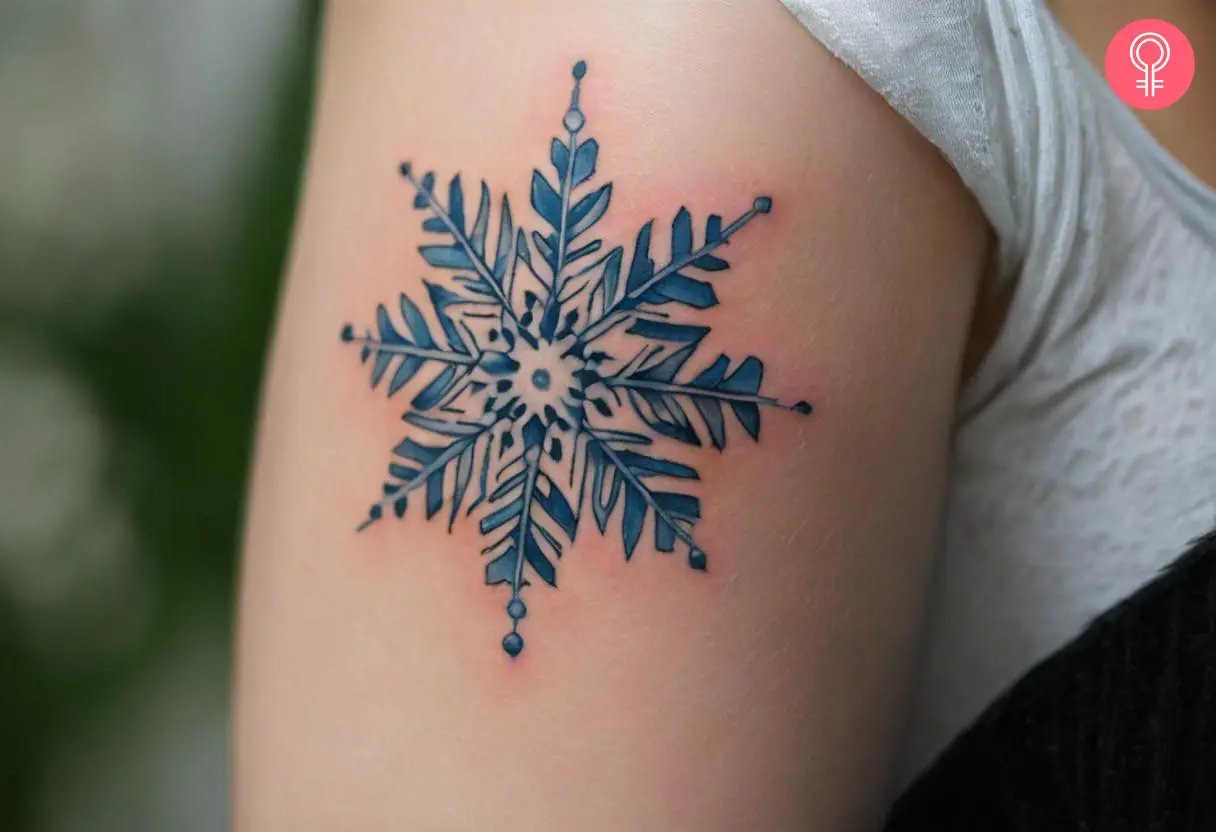 Woman with a realistic snowflake tattoo