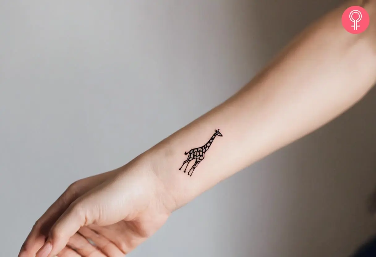 Woman with a small wrist giraffe tattoo