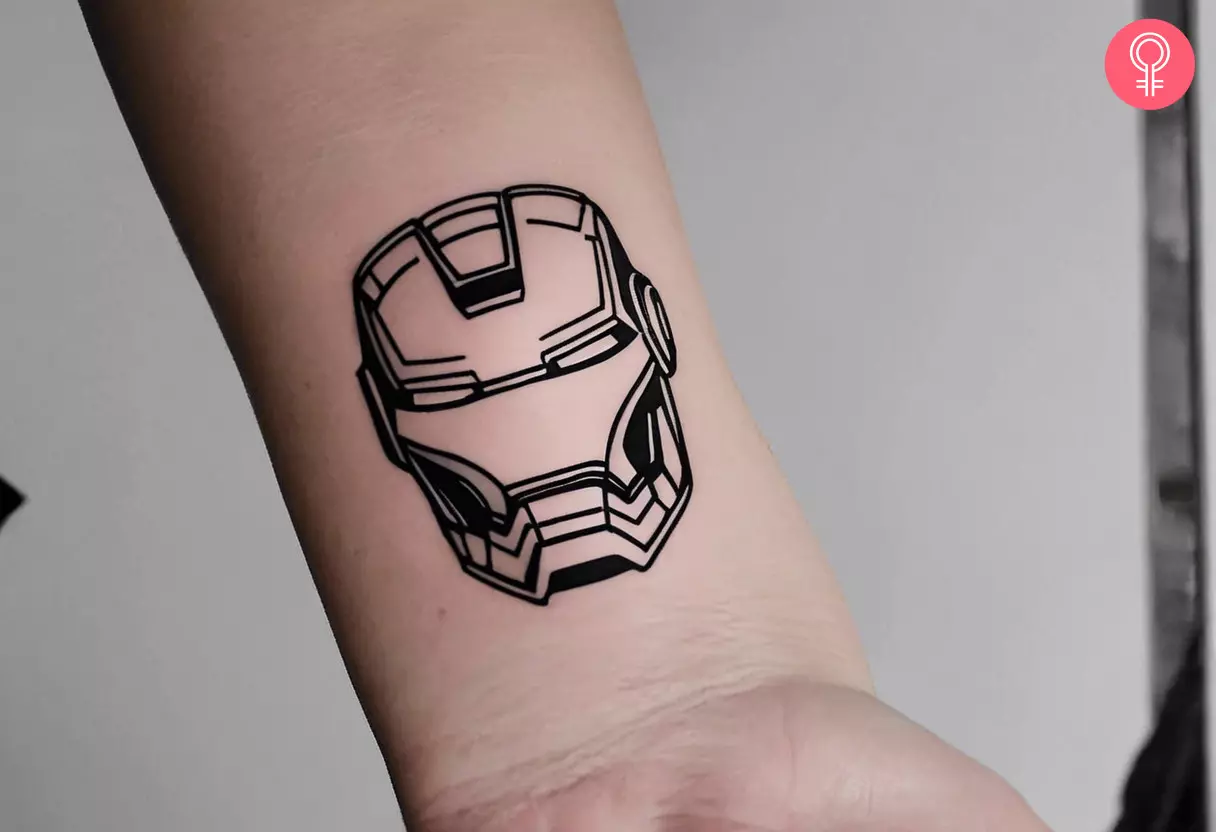 Woman with an Iron Man helmet tattoo on her wrist