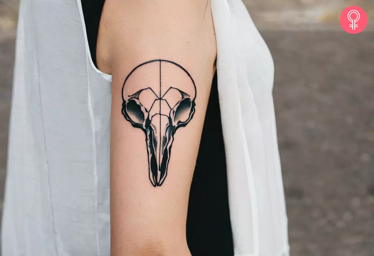 Woman with bird skull tattoo on her arm