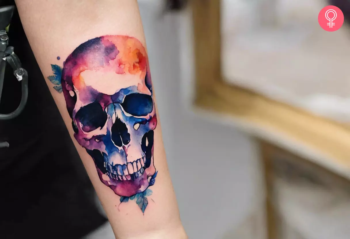 Woman with skull forearm tattoo