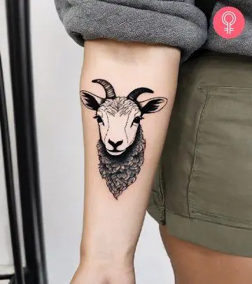 A woman with a lamb tattoo on the forearm