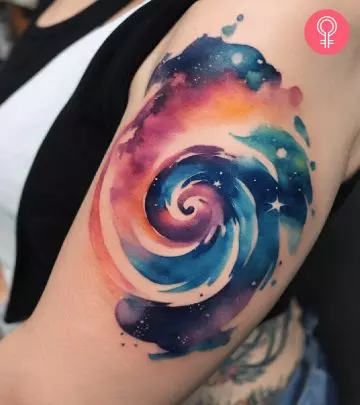 A woman with a spiral tattoo on the upper arm