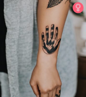 Baby footprint tattoo on a woman’s arm