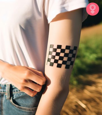 A woman with an astronaut tattoo on her arm.