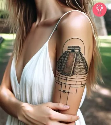 Pagoda tattoo on the upper arm of a woman