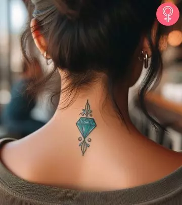 A woman with a diamond tattoo on her upper arm