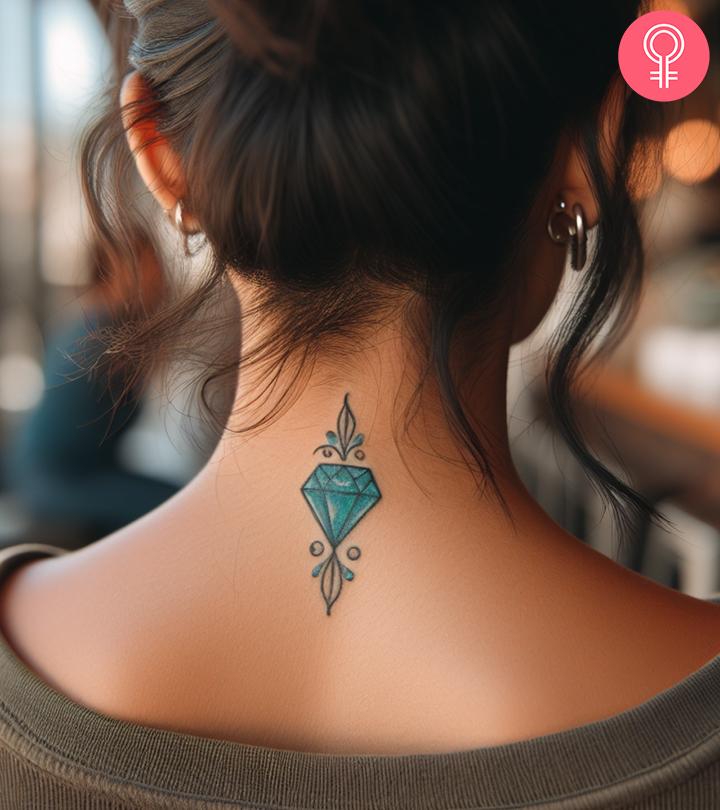 A gem tattoo on the nape of the neck of a woman