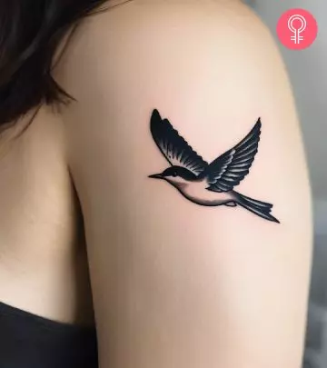 Nightingale tattoo on a woman’s upper arm