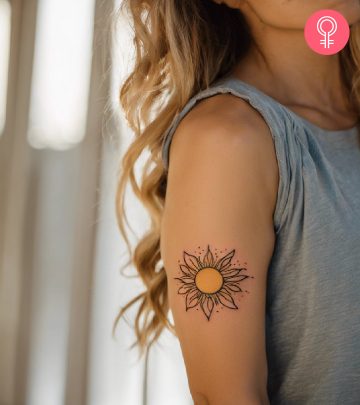 Woman with sun tattoo on her arm