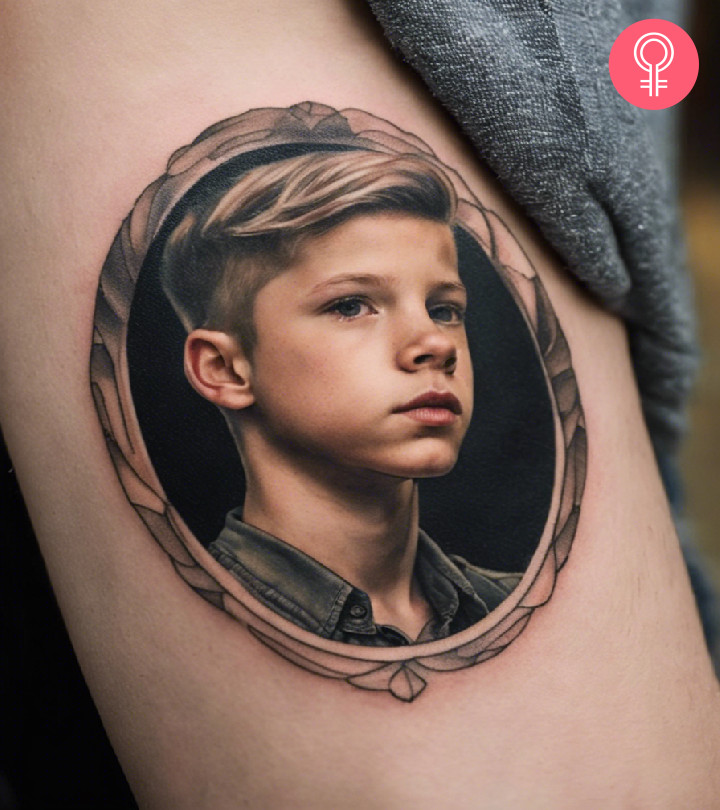 A man wearing a boy’s face portrait tattoo on the upper arm.