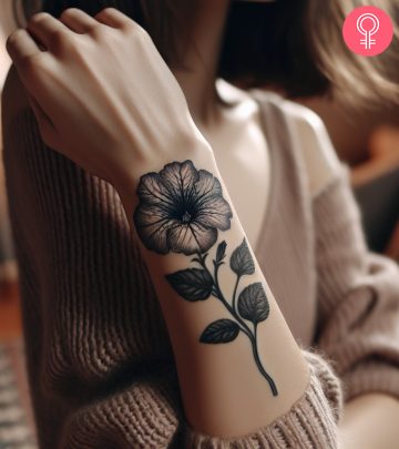 August birth flower tattoo on the woman’s arm