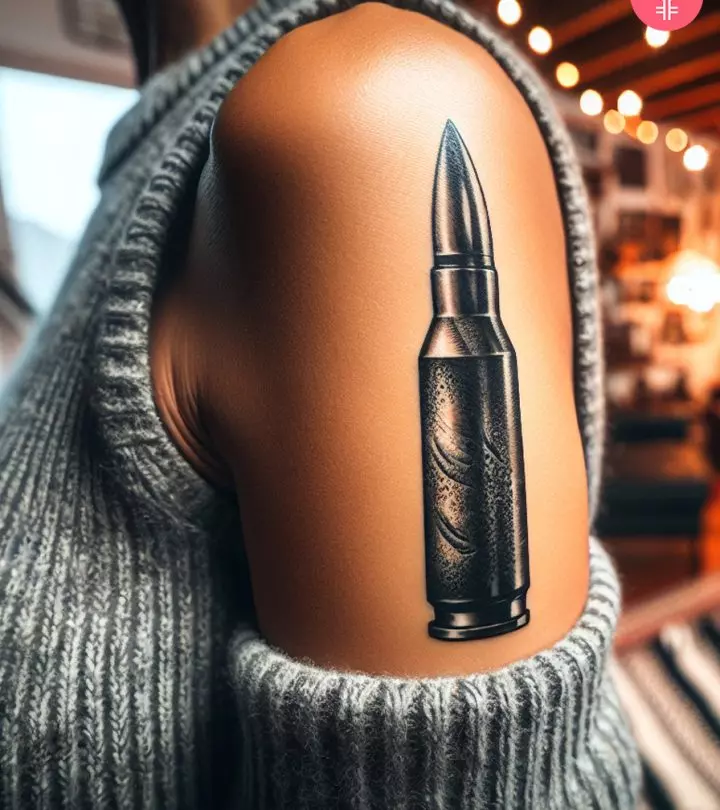 Woman with a bullet tattoo on the upper arm