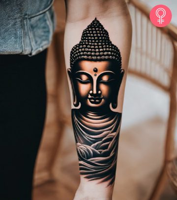 A woman with a Sanskrit tattoo on her upper arm