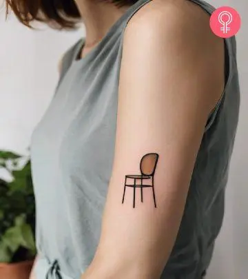 A woman with a spark plug tattoo on her upper arm