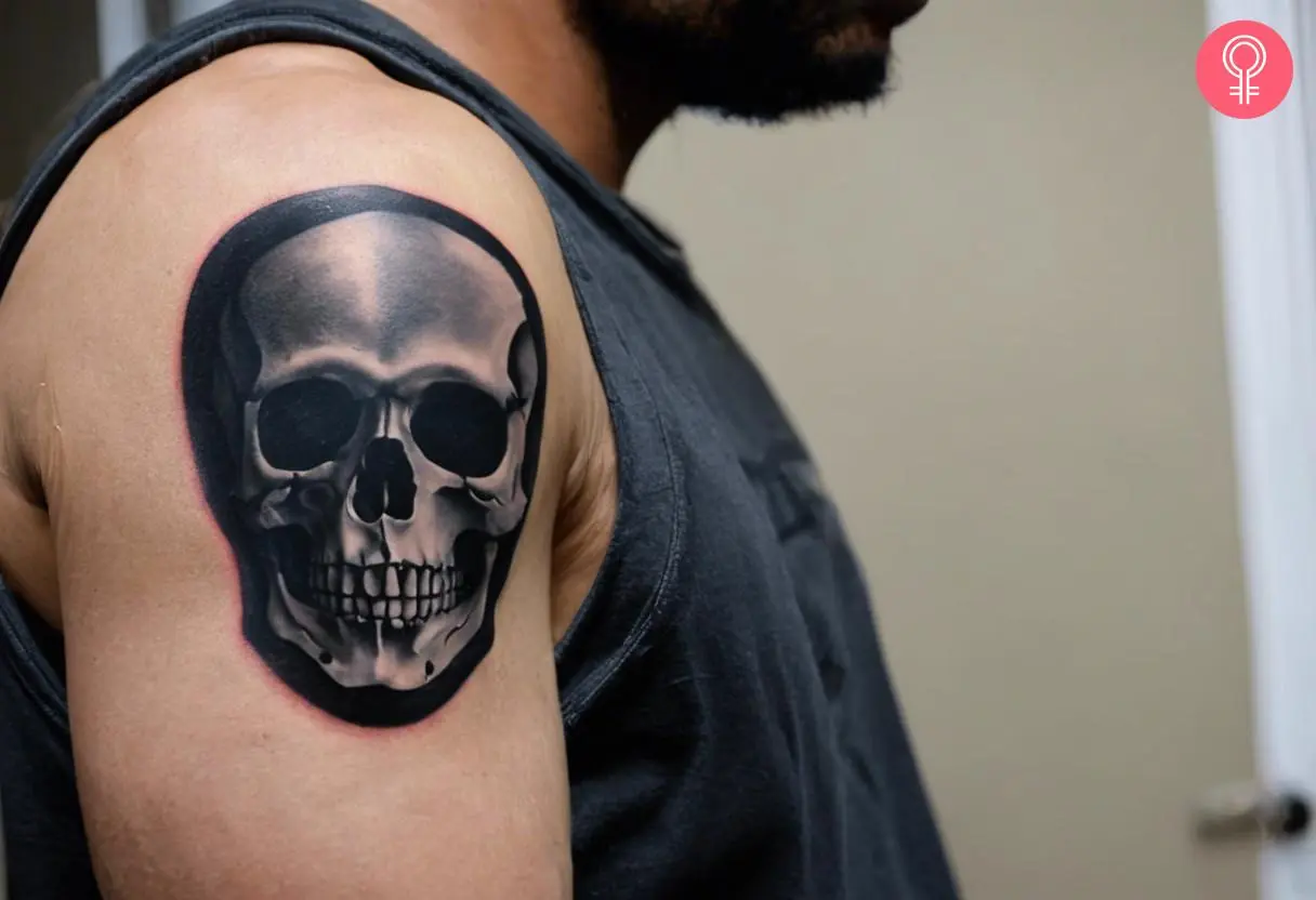 A Deftones skull tattoo on a man’s upper arm