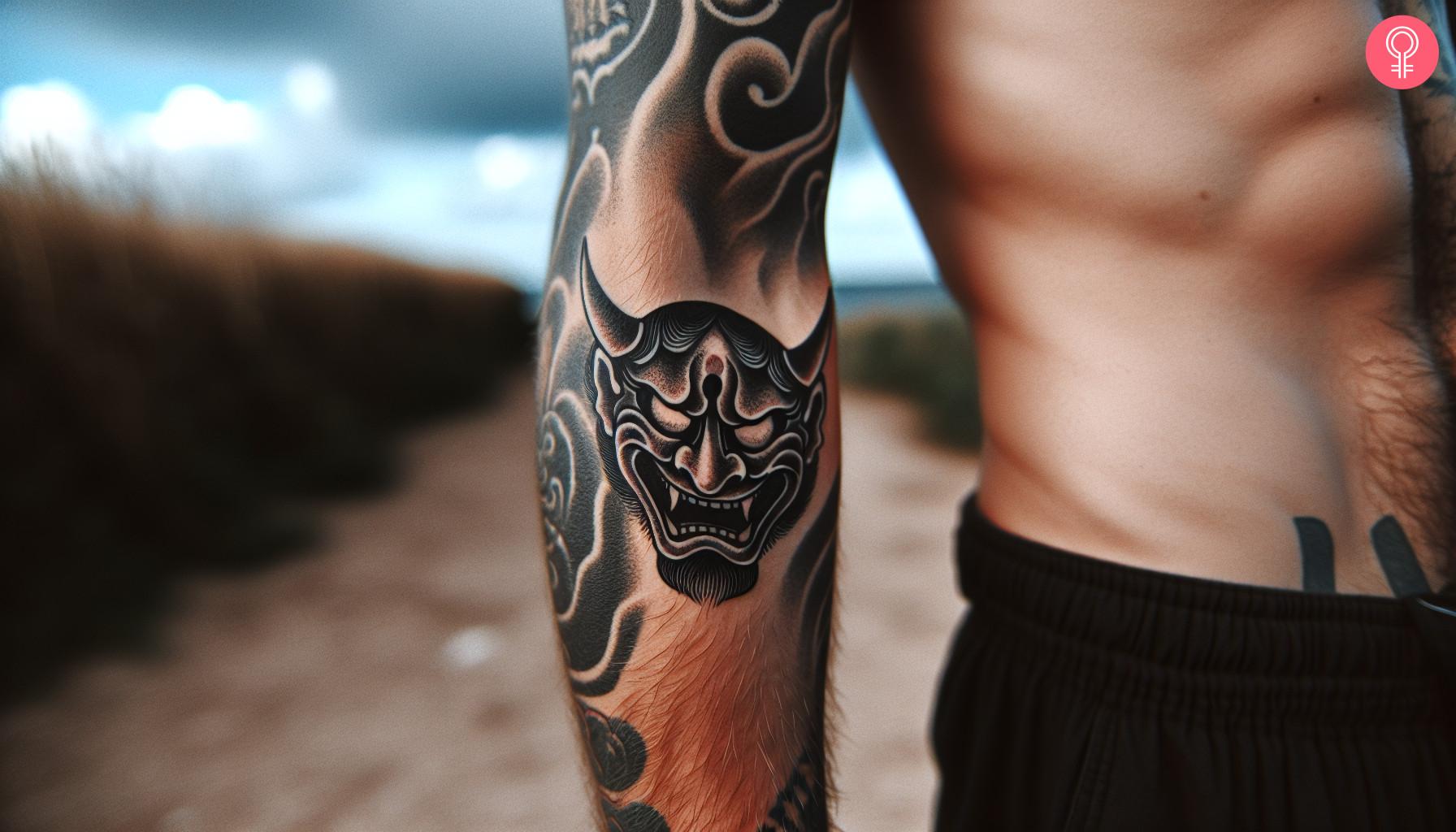 A Japanese devil mask tattoo on a man's forearm