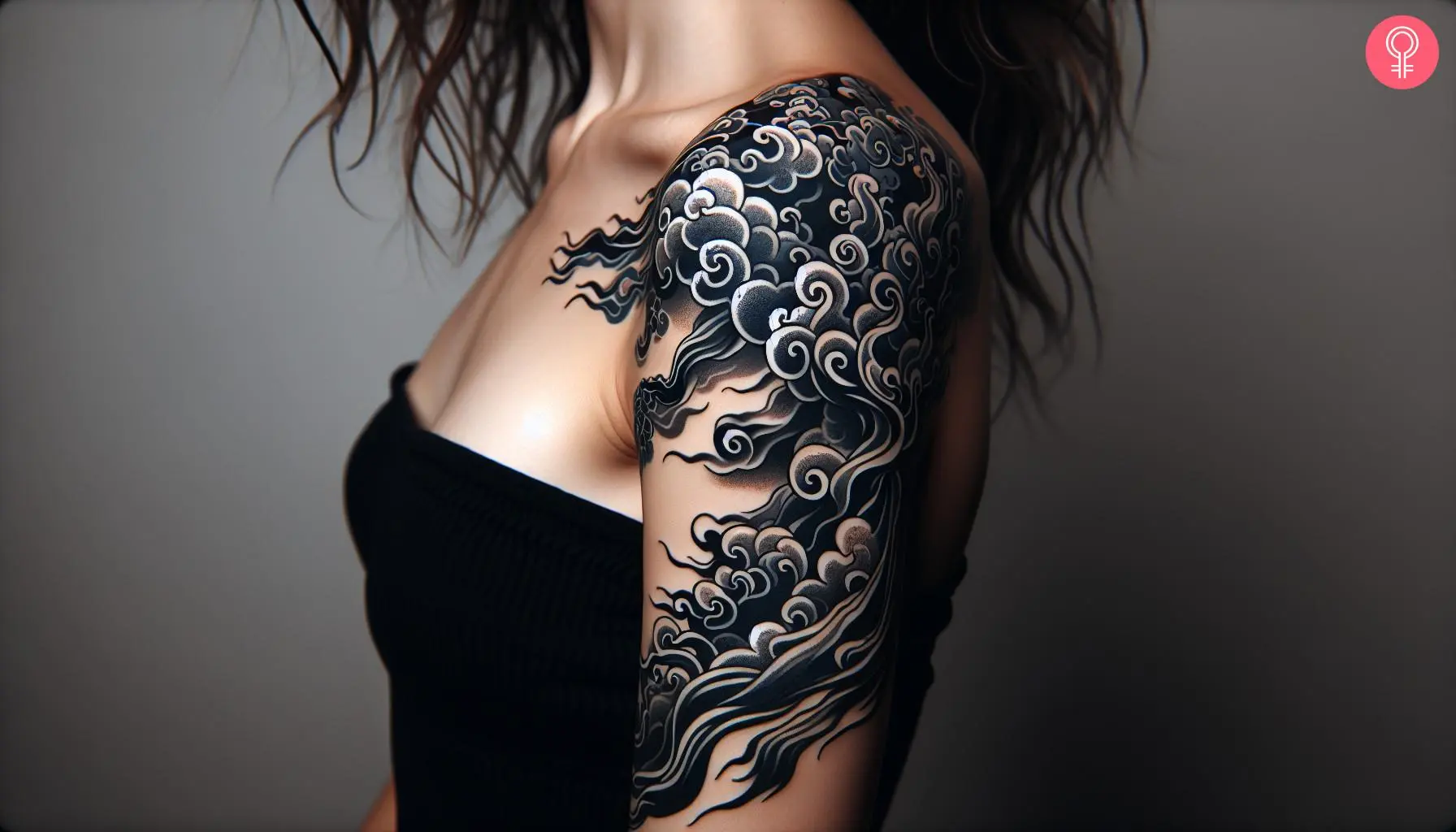 A Japanese smoke tattoo on a woman’s upper arm