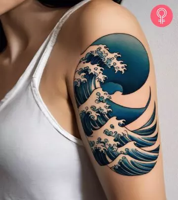 A graphic tattoo on a woman’s upper arm