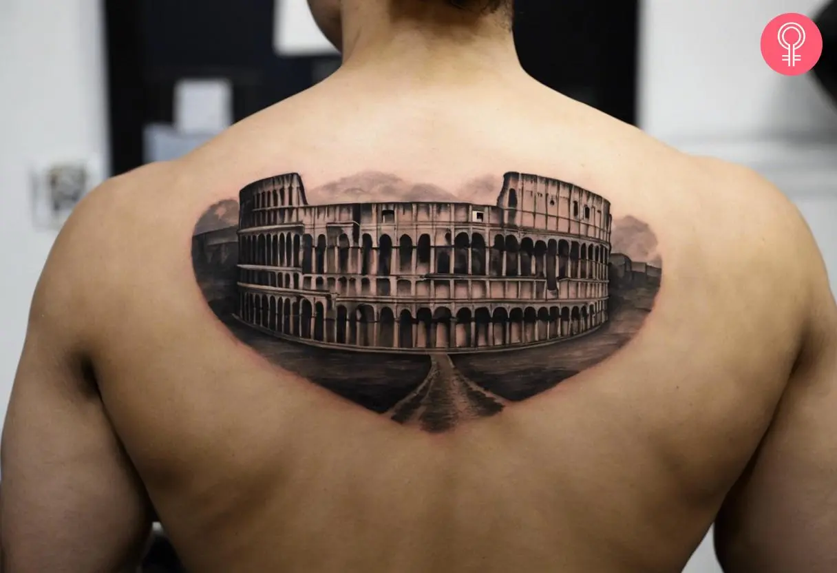 A Roman Colosseum tattoo on the upper back of a man