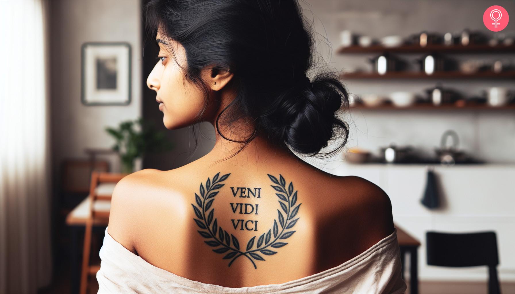 A Roman laurel wreath tattoo on a woman’s upper back