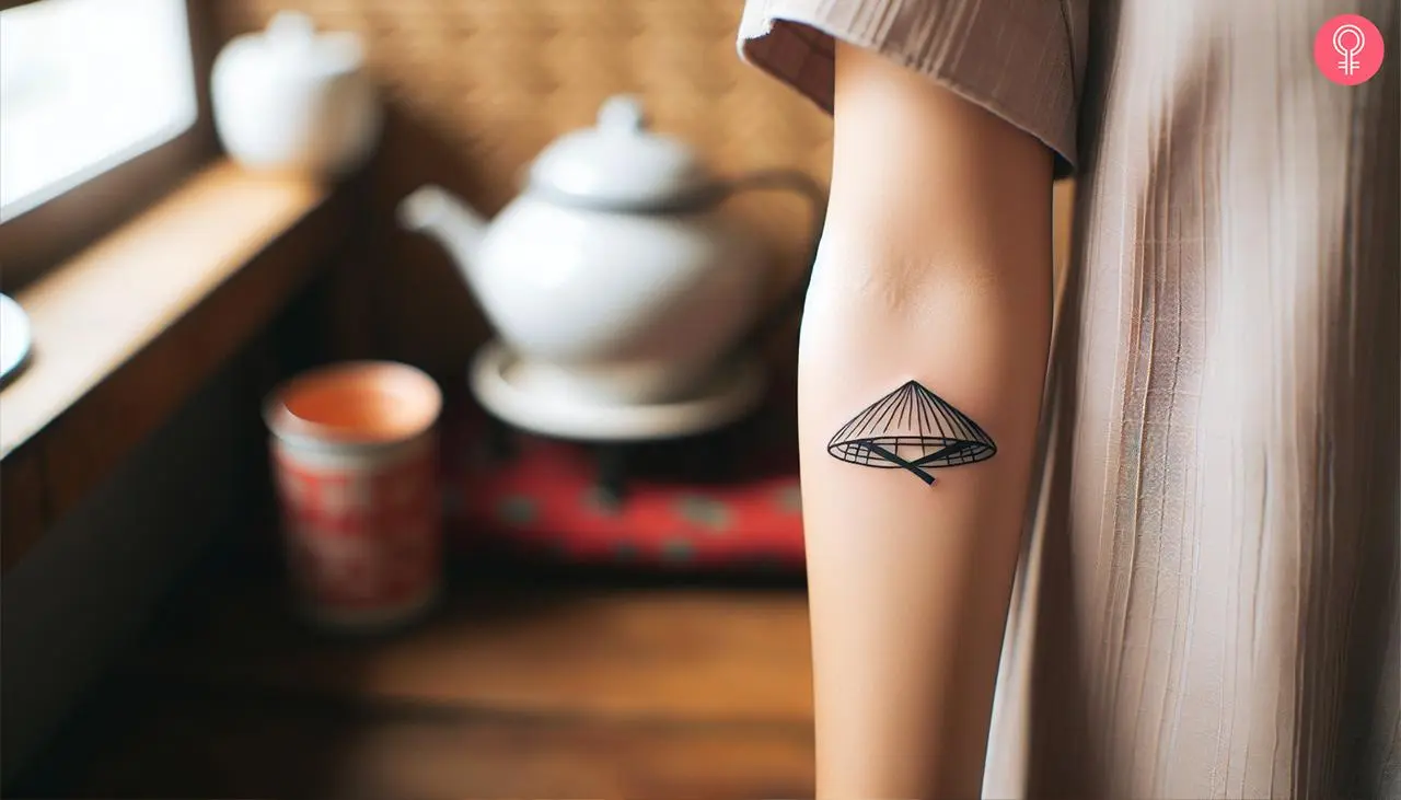 A Vietnamese hat tattoo on a woman’s forearm