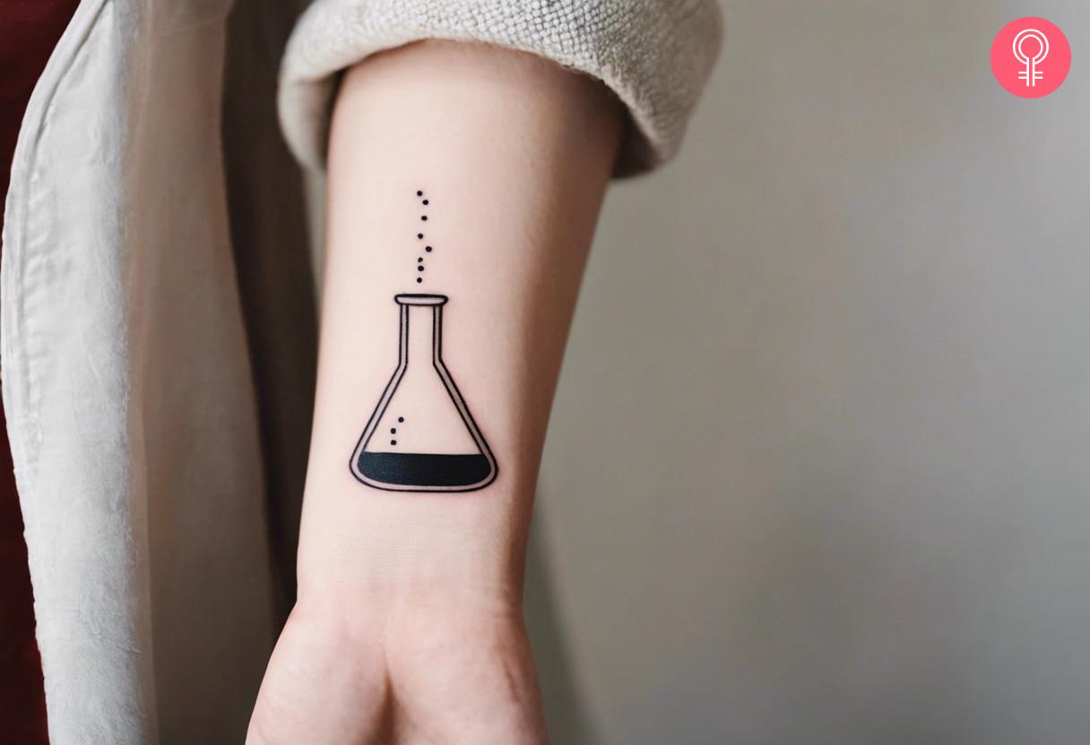 A cup tattoo on a woman's forearm