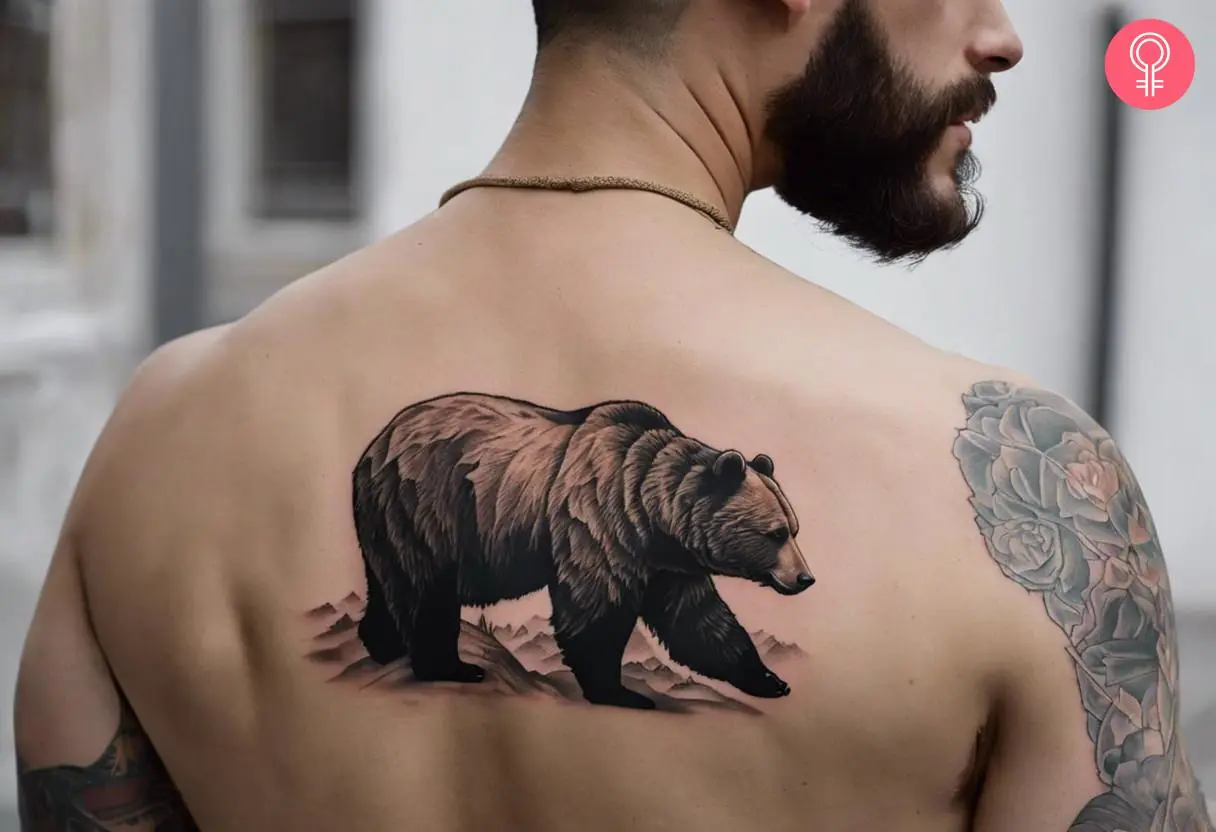 A bear tattoo on a man’s upper back