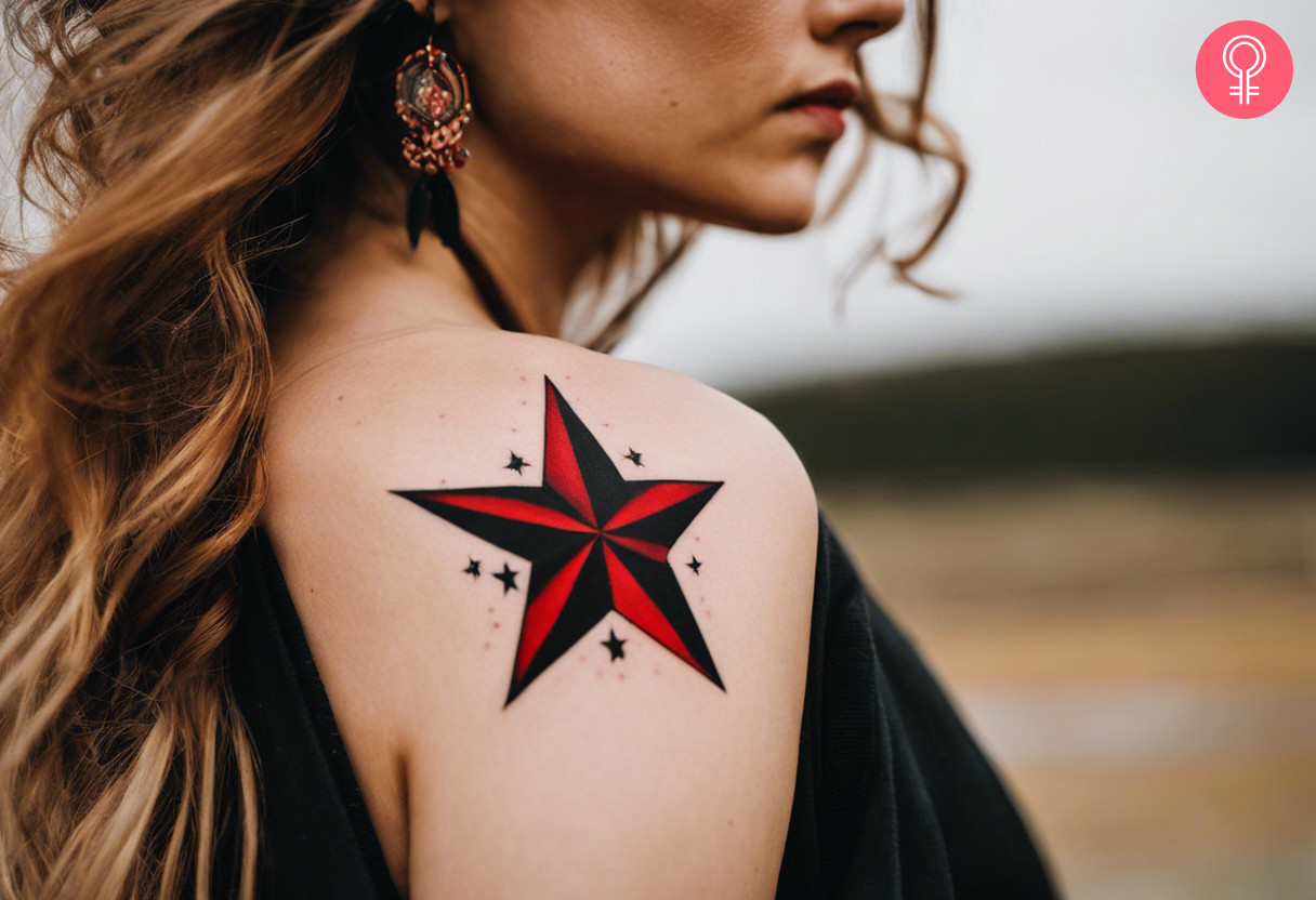 A black and red star tattoo on a woman’s forearm