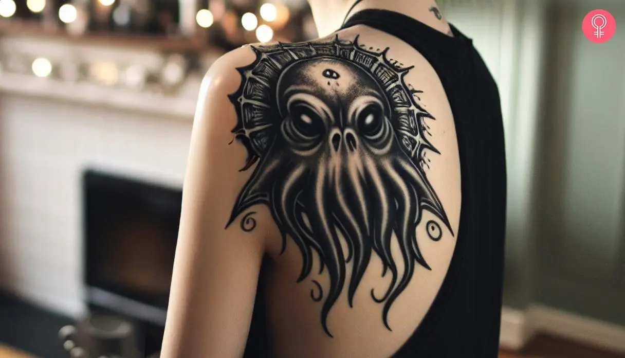 A black-and-white Cthulhu tattoo on a woman’s shoulder