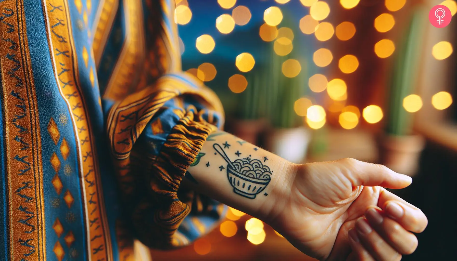 A bowl of pasta tattoo on a woman’s wrist