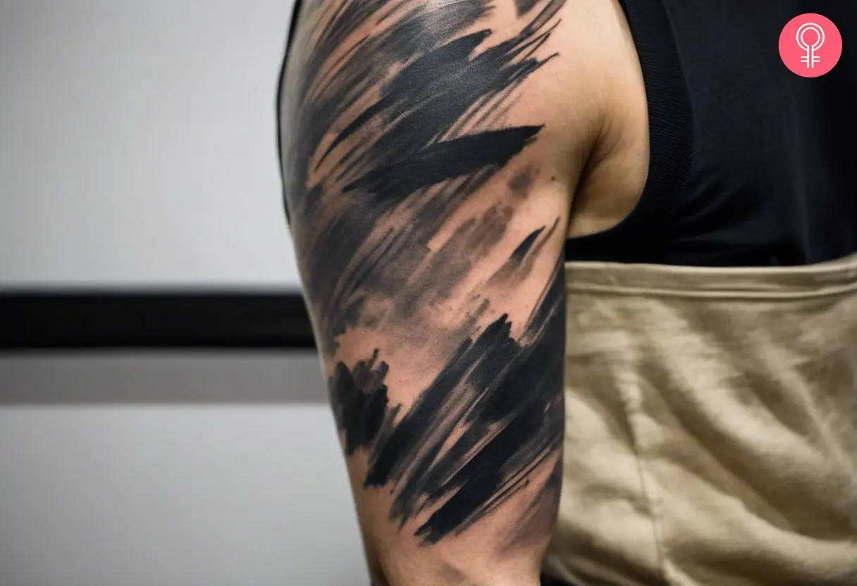 A brush stroke tattoo sleeve on the arm