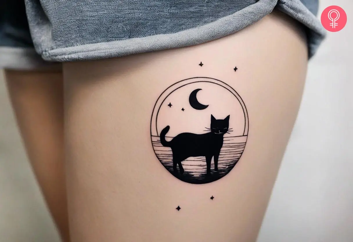 A cat and moon silhouette tattoo on the thigh